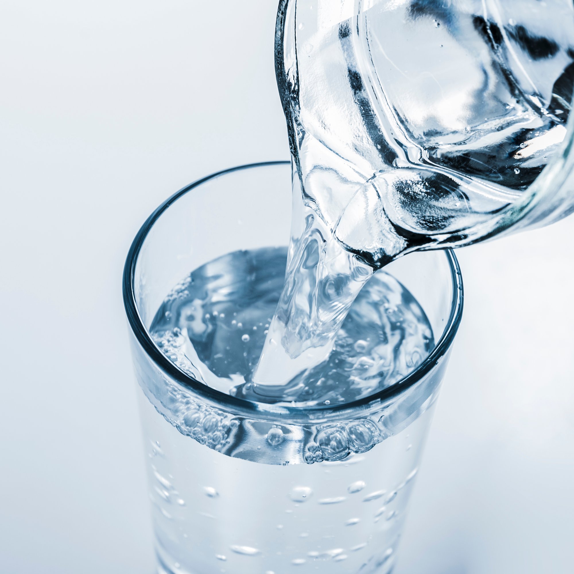 top-view-jar-filling-glass-water